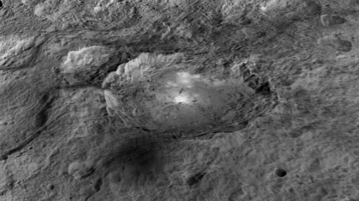 The intriguing brightest spots on Ceres lie in a crater named Occator, which is about 60 miles (90 kilometers) across and 2 miles (4 kilometers) deep. Credits: NASA/JPL-Caltech/UCLA/MPS/DLR/IDA/LPI